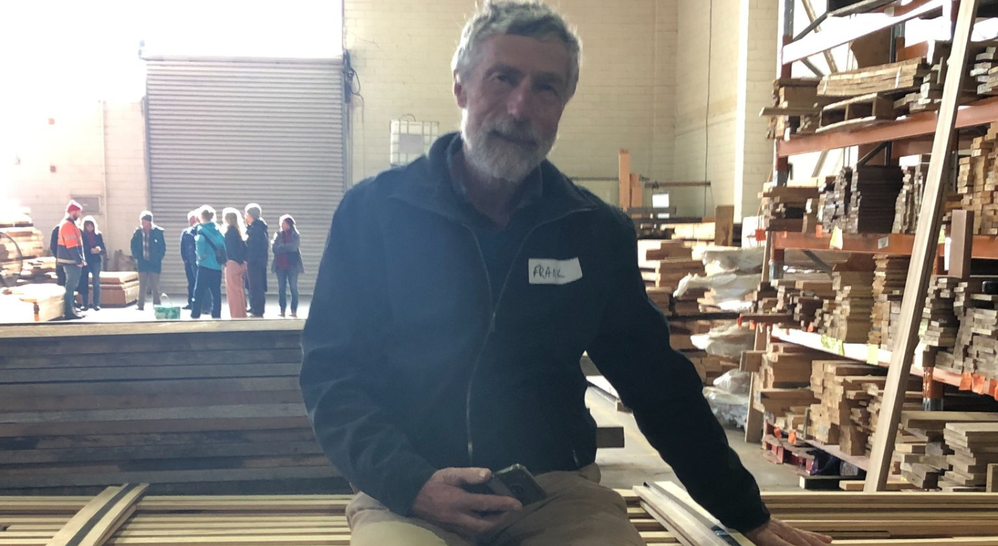 Frank Hirst sitting atop his Southern Blue Gum Cladding at CERES Fair Wood