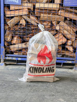 A bag of kindling in front of firewood