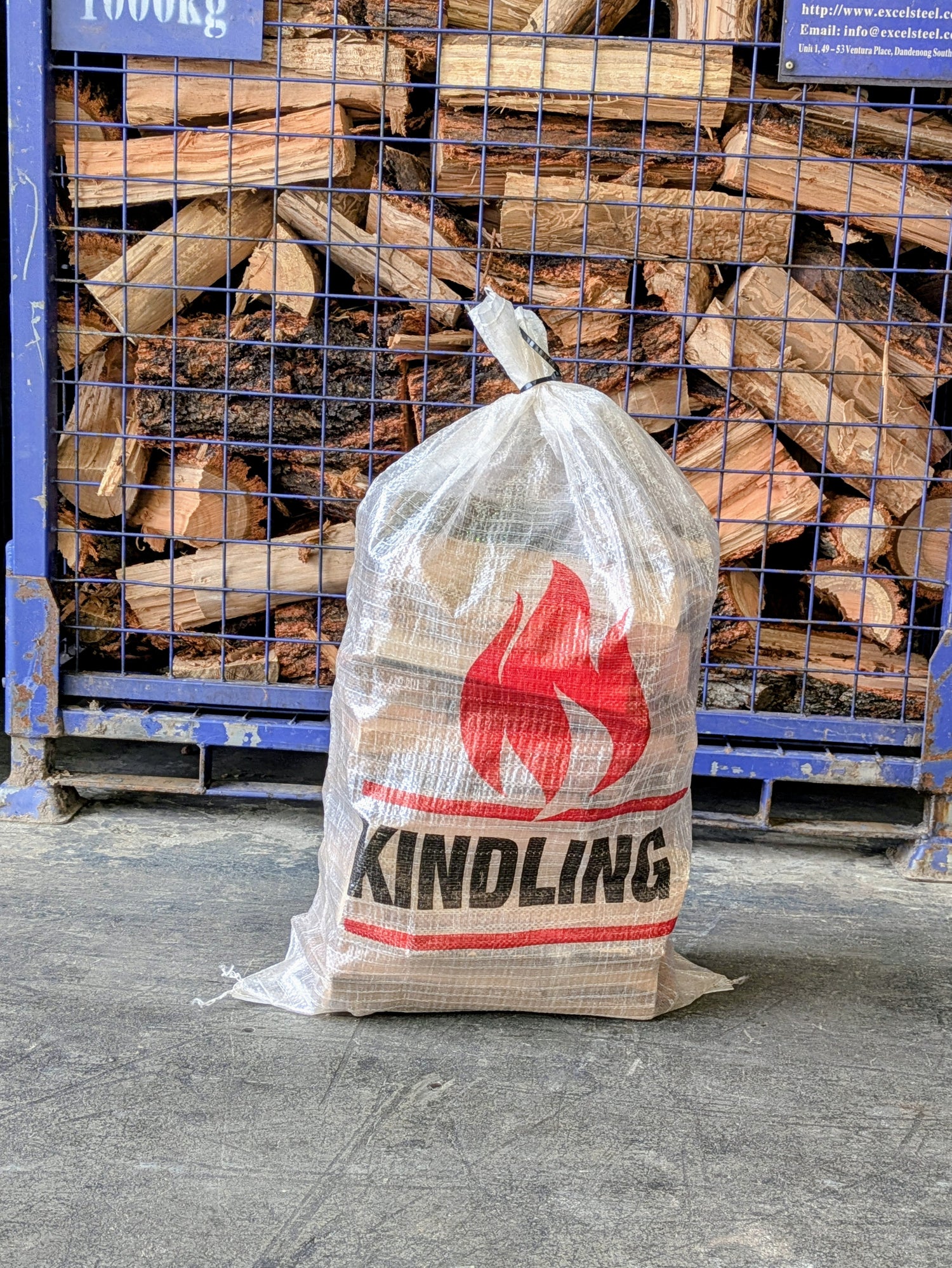 A bag of kindling in front of firewood